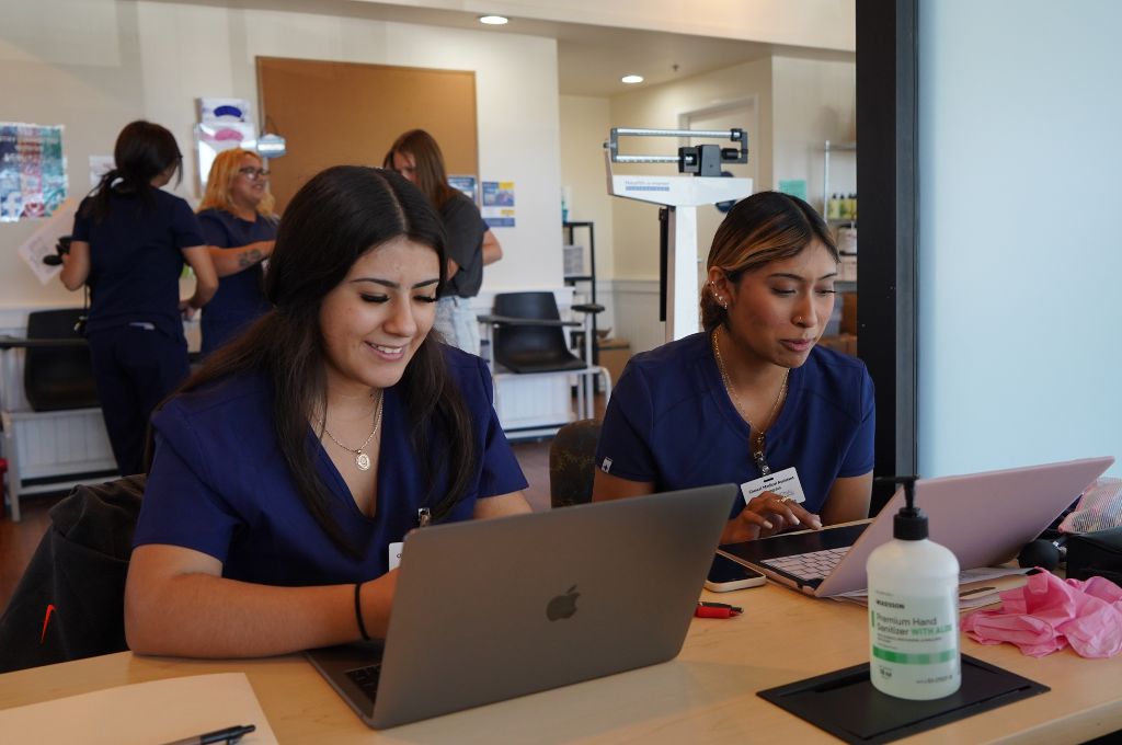 Medical administrative assistants performing computer-related medical assistant duties.