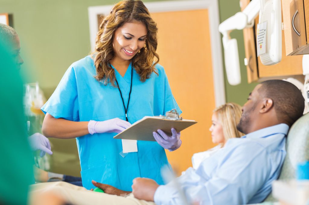 A medical assistant reviews a patient's records.